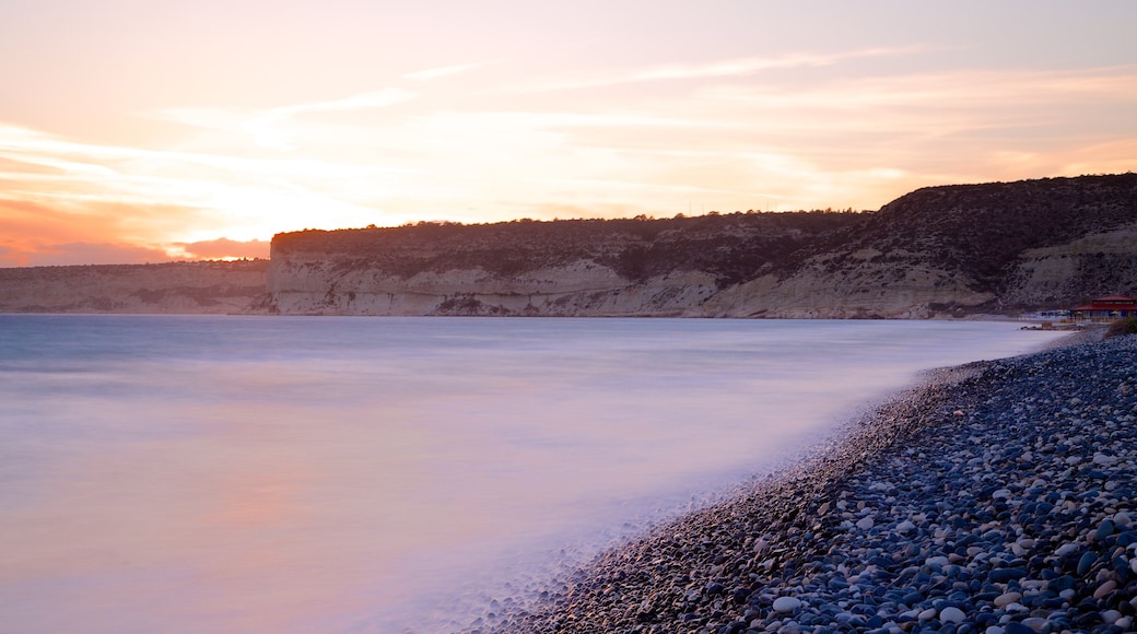 Cyprus featuring a sunset and a pebble beach