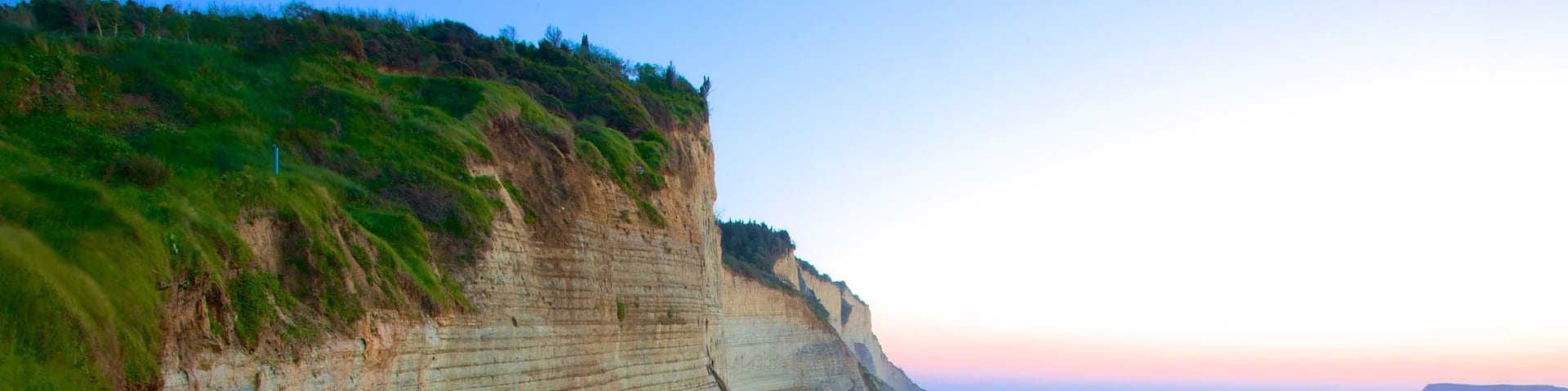 Sunset Beach showing rugged coastline and a sunset