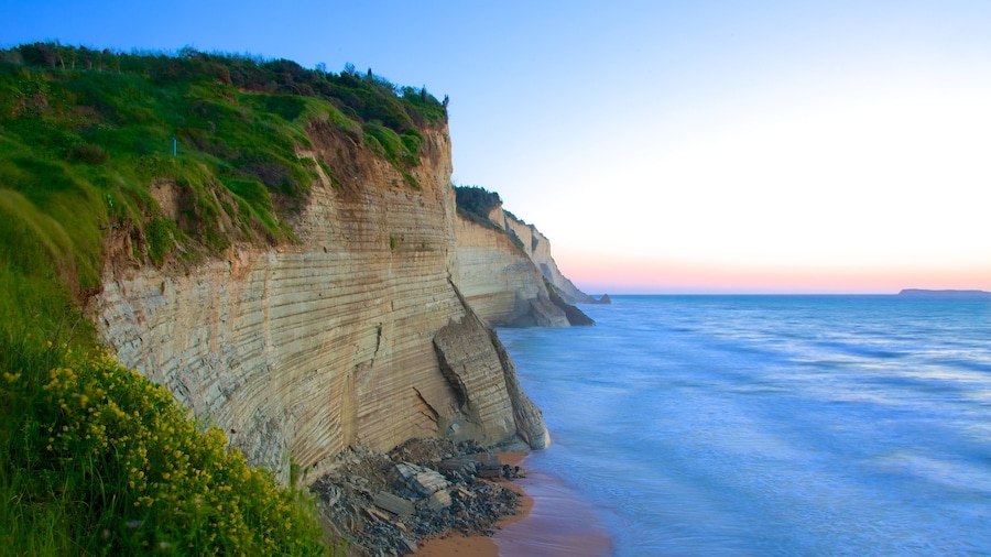 Sunset Beach featuring a sunset and rocky coastline