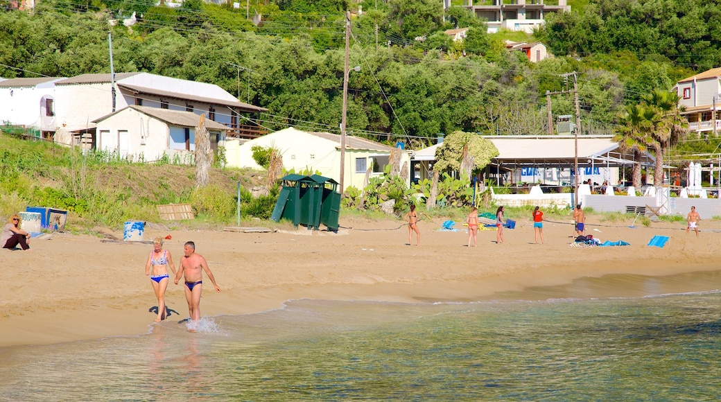 Pelekas Beach showing a sandy beach and a coastal town as well as a couple