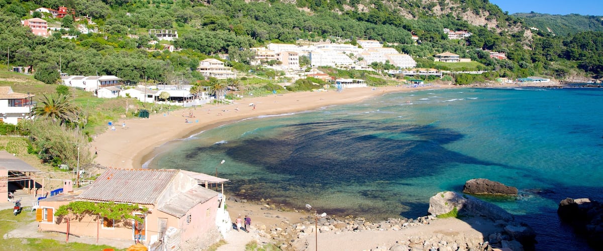 Pelekas Beach showing a coastal town, landscape views and a beach
