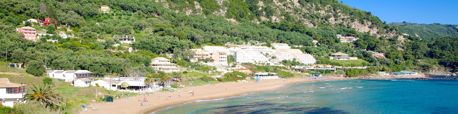 Pelekas Beach showing a coastal town, landscape views and a beach