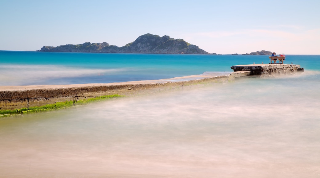 Arillas Beach showing landscape views, a bay or harbor and a sandy beach