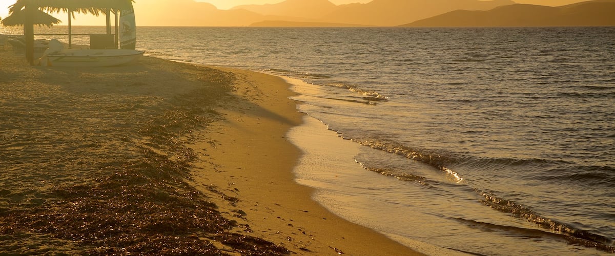 Tigaki Beach featuring a sunset and a sandy beach
