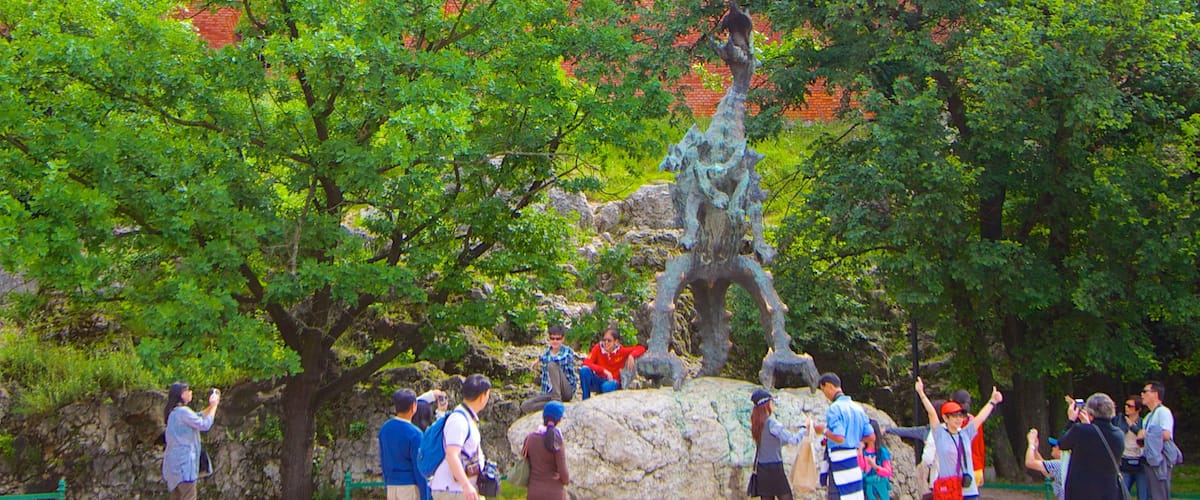 Poland showing a statue or sculpture as well as a large group of people