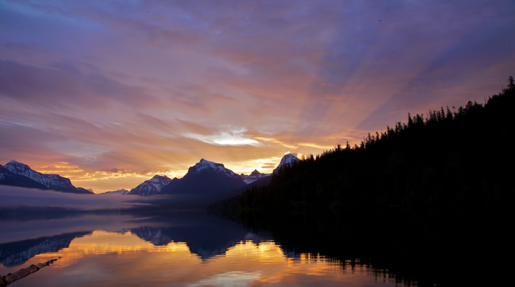 Glacier National Park showing a lake or waterhole and a sunset