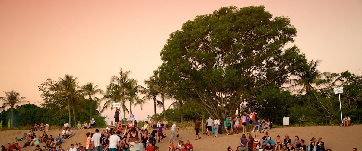 Mindil Beach which includes a sandy beach and a sunset as well as a large group of people