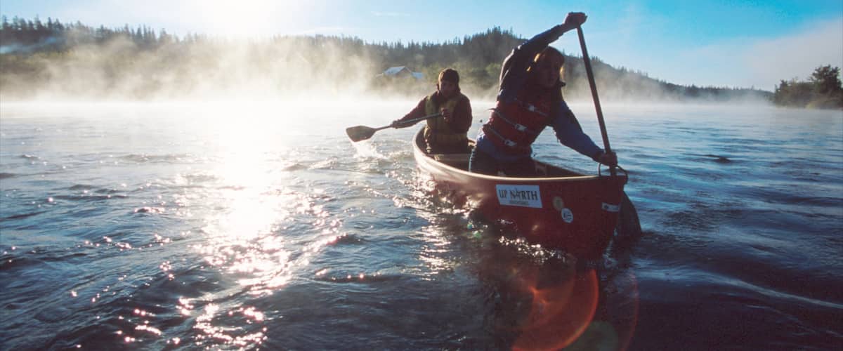Yukon which includes mist or fog, a lake or waterhole and kayaking or canoeing