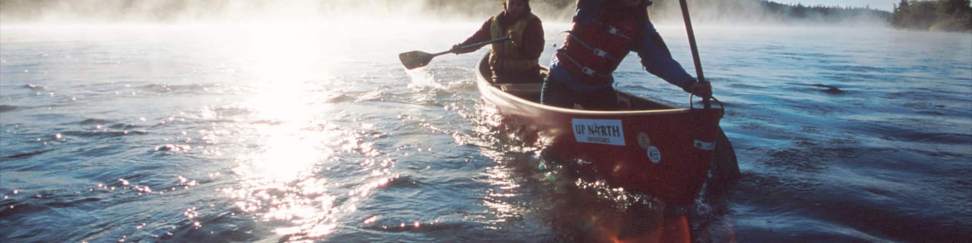 Yukon which includes mist or fog, a lake or waterhole and kayaking or canoeing