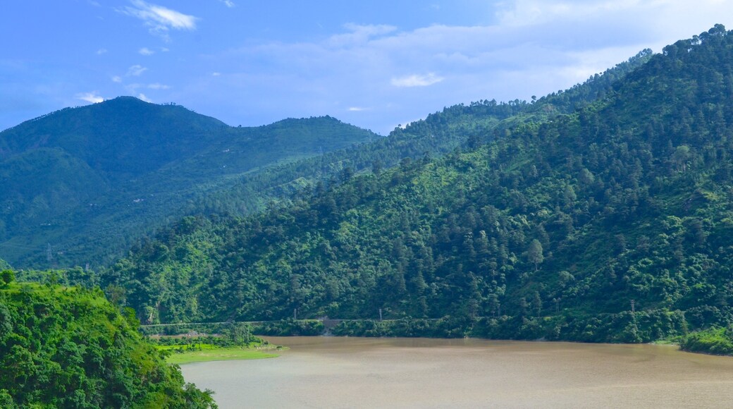 Manali which includes a river or creek and mountains