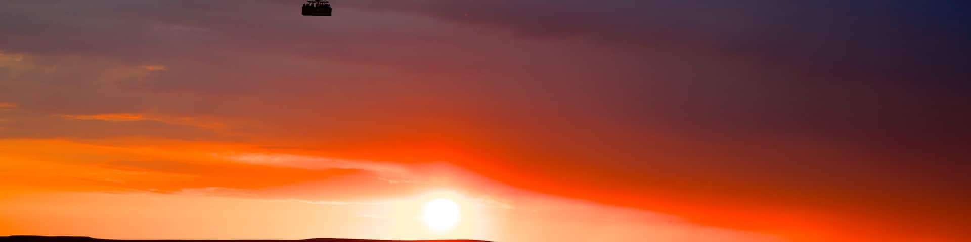 Cappadocia featuring ballooning and a sunset