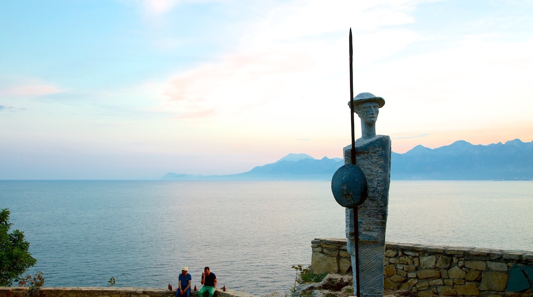 Karaalioglu Park showing a statue or sculpture, a garden and a coastal town