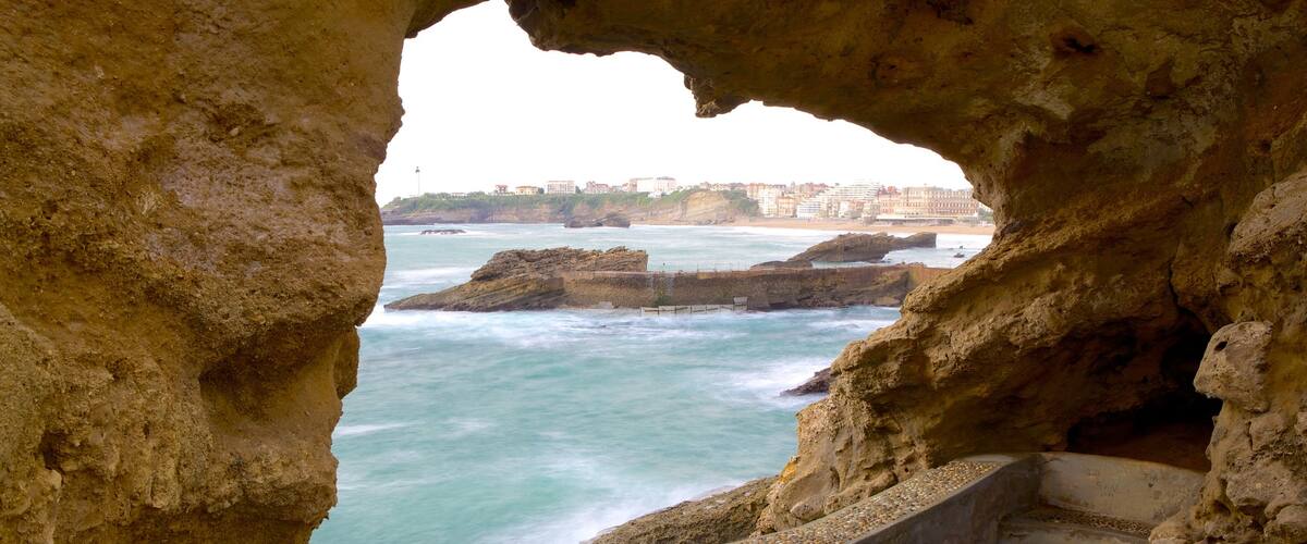 Old Harbor showing caves and rugged coastline