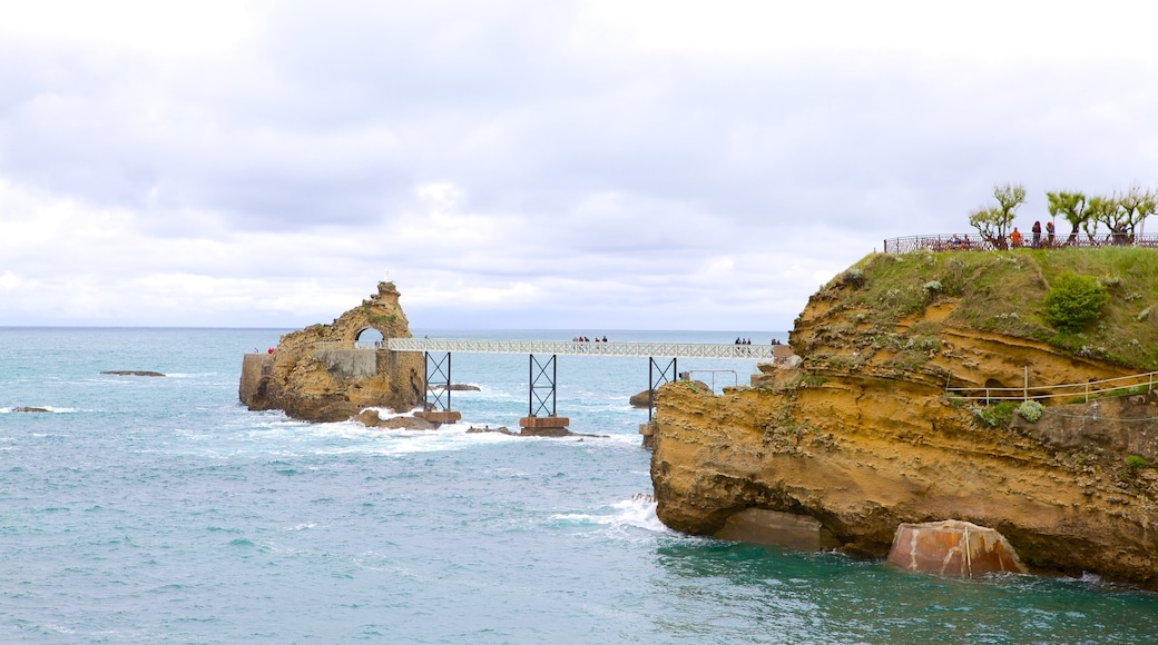 Cote des Basques featuring rugged coastline and a bridge