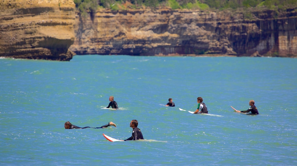 Grand Beach which includes surfing and rocky coastline as well as a small group of people