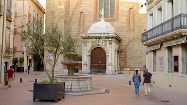 Perpignan showing a square or plaza and street scenes as well as a small group of people