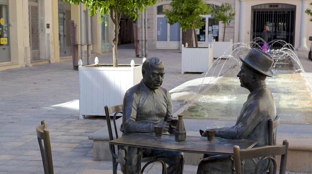 Old Town which includes a square or plaza and a statue or sculpture