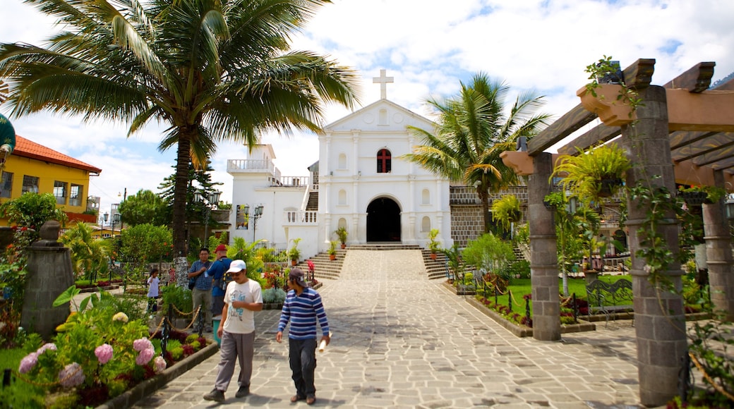 Chiesa di San Pietro mostrando chiesa o cattedrale e giardino cosi come un piccolo gruppo di persone