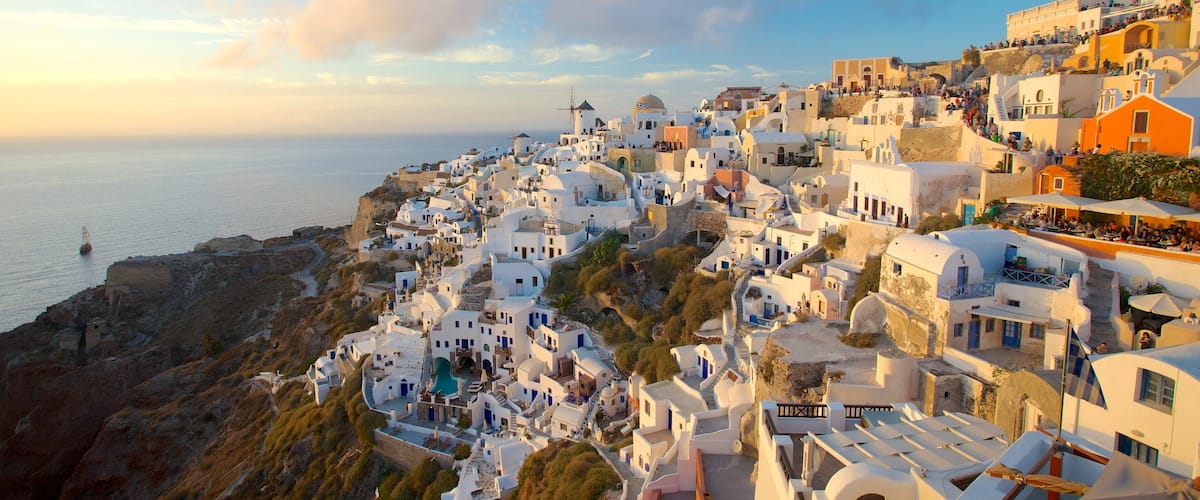Oia featuring a sunset and a coastal town