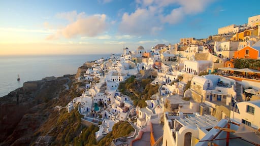 Oia which includes a coastal town and a sunset