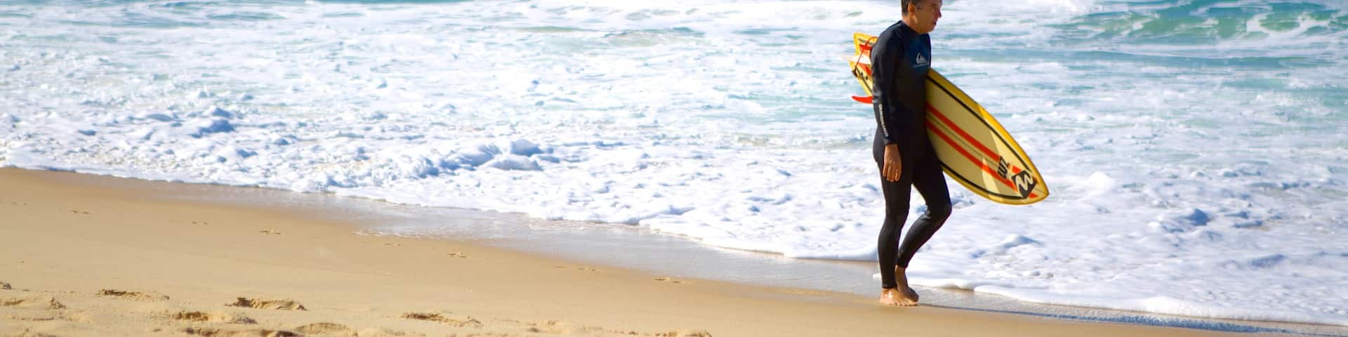 Mole Beach featuring surfing and a beach as well as an individual male