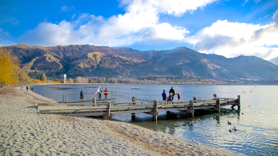 Lake Wanaka which includes a lake or waterhole, a beach and landscape views