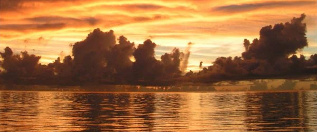 Saipan which includes a sunset, general coastal views and a coastal town