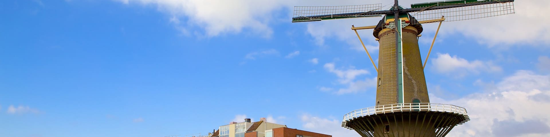 Delfshaven showing a windmill, a bay or harbor and a river or creek