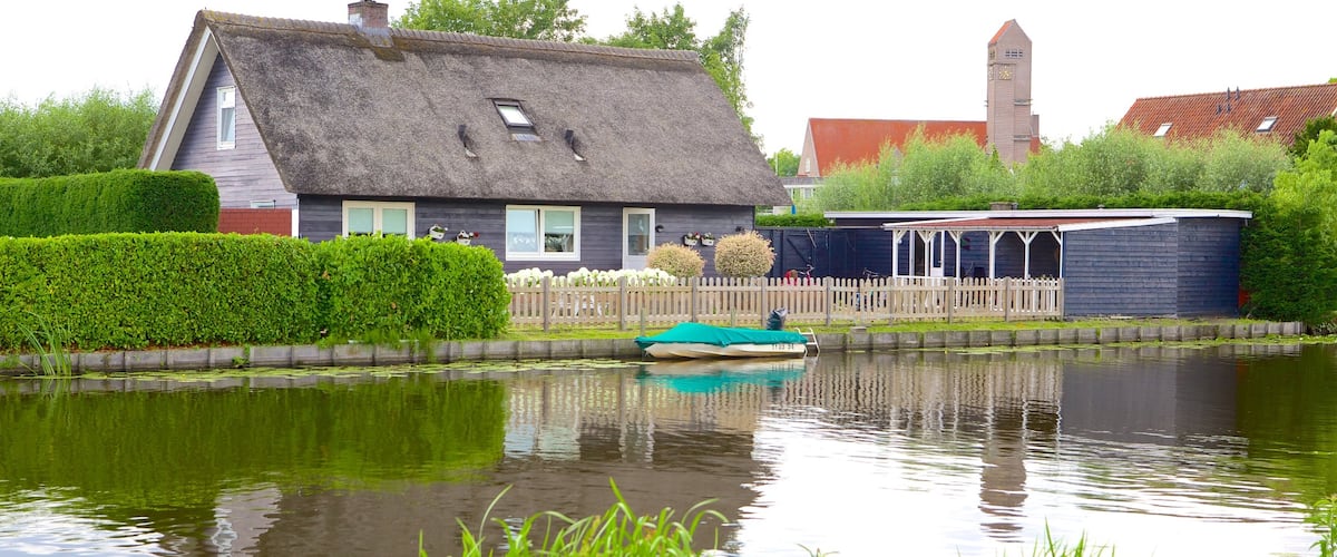 Kinderdijk featuring a river or creek, a house and farmland