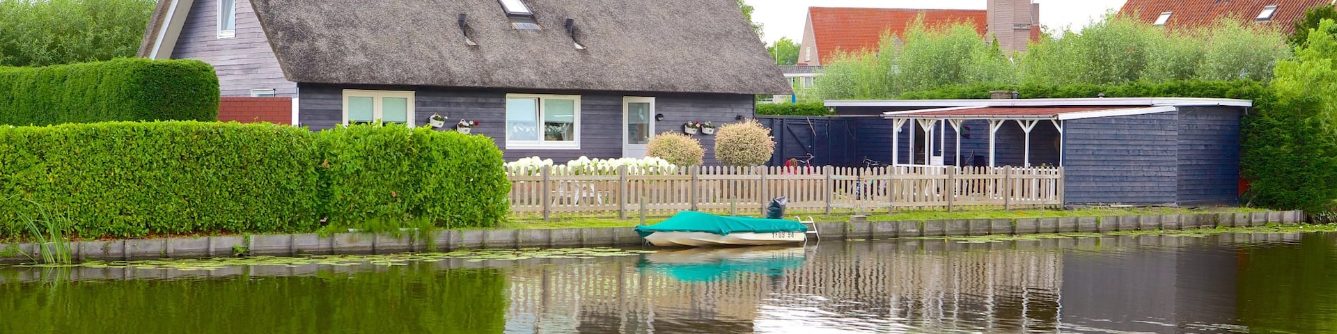 Kinderdijk welches beinhaltet Fluss oder Bach, Farmland und Haus