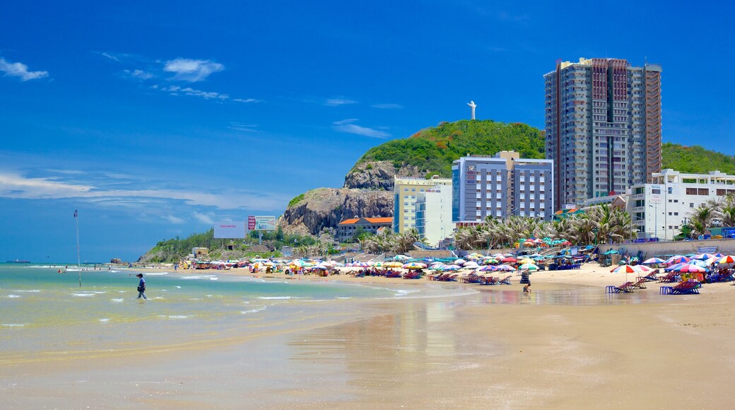 Back Beach which includes a coastal town and a sandy beach