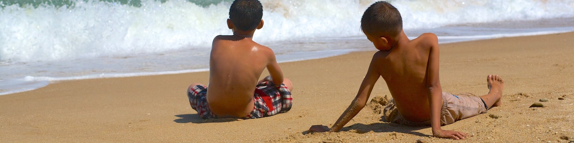 Phan Thiet Beach showing a sandy beach as well as children