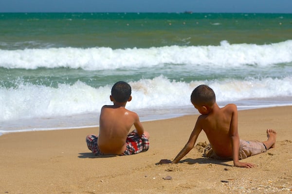 Phan Thiet Beach showing a sandy beach as well as children