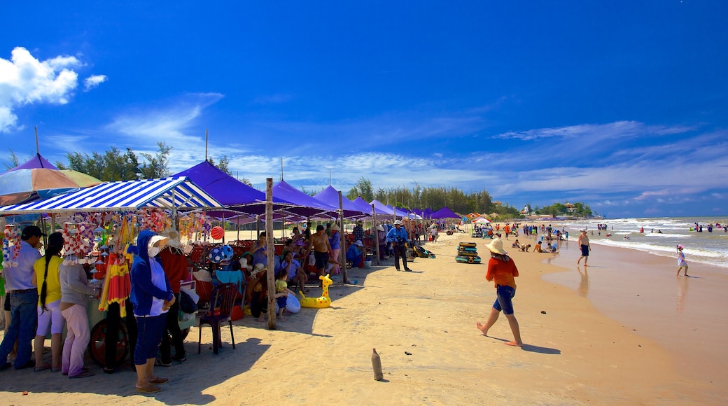 Long Hai Beach showing a sandy beach as well as a large group of people