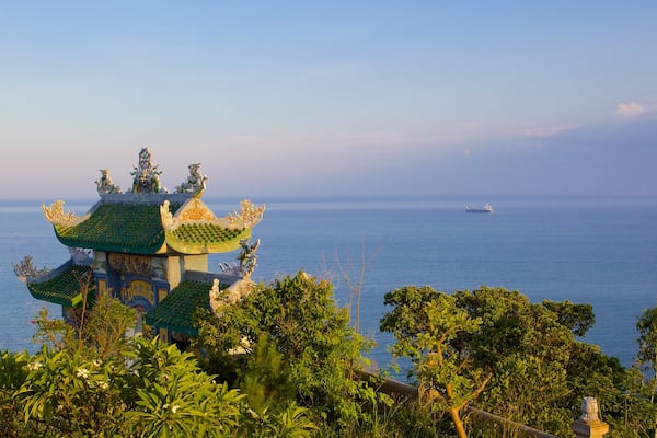 Son Tra Mountain which includes general coastal views and a temple or place of worship