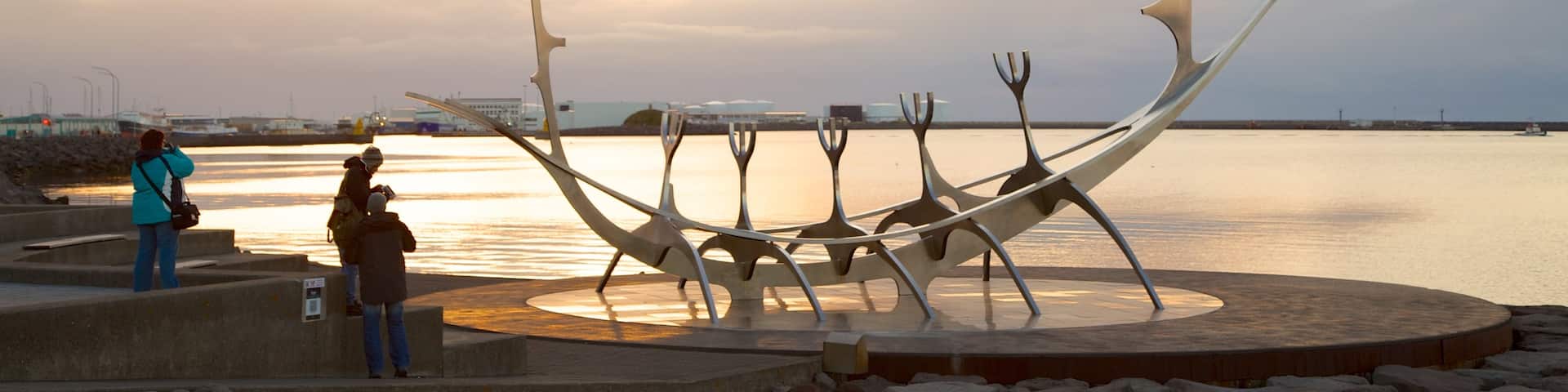 Reykjavik Harbour featuring a sunset, general coastal views and outdoor art