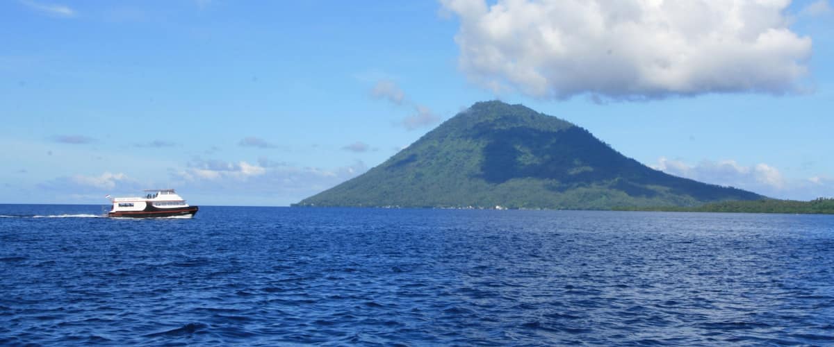 Manado which includes general coastal views, boating and mountains