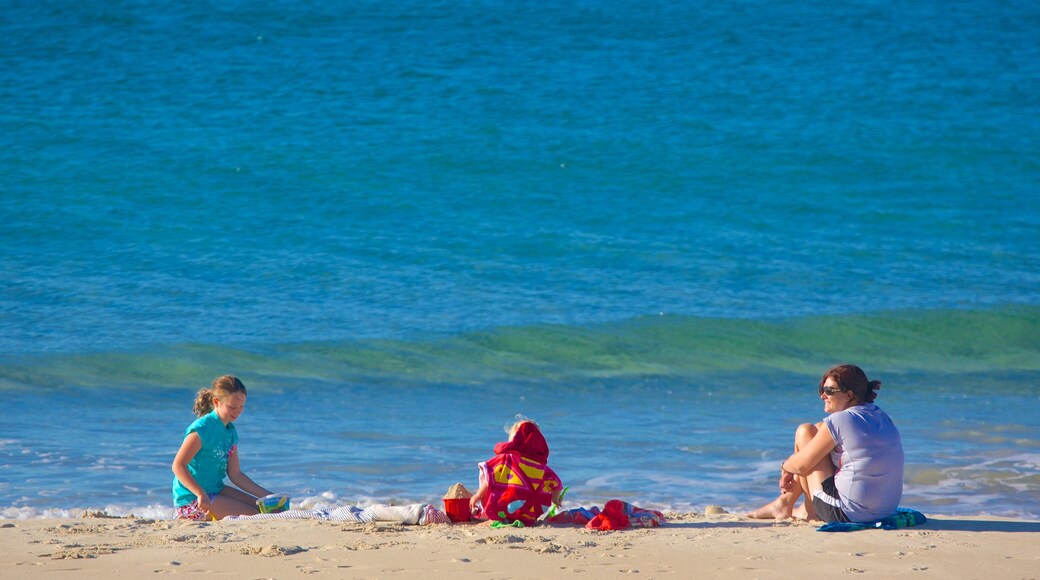 Kings Beach which includes a coastal town and a sandy beach as well as a family