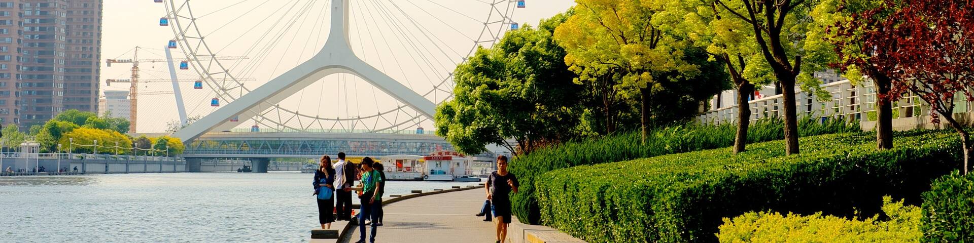 Tianjin Eye which includes street scenes, rides and a river or creek