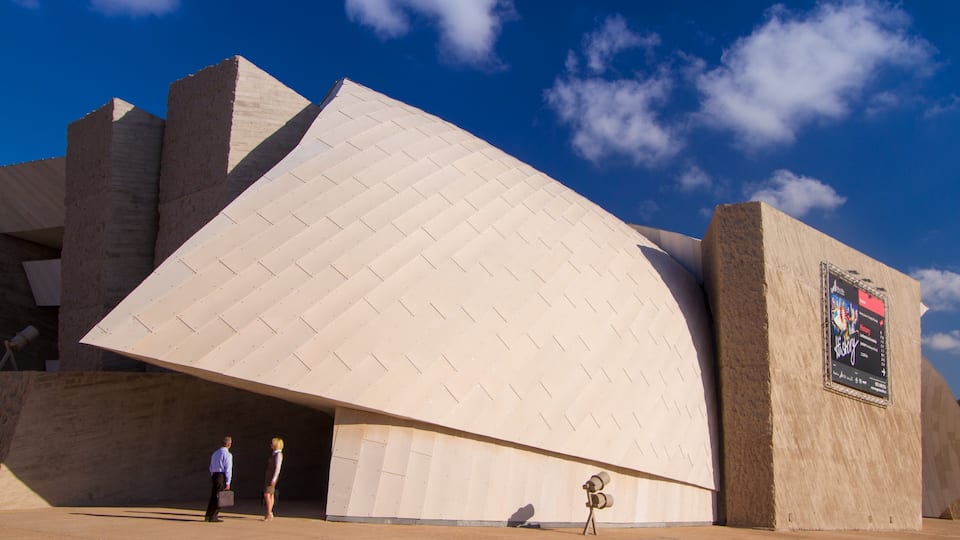 Adeje which includes modern architecture as well as a small group of people