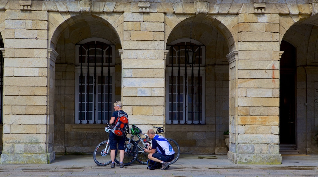 Obradoiro Square which includes cycling and street scenes as well as a couple