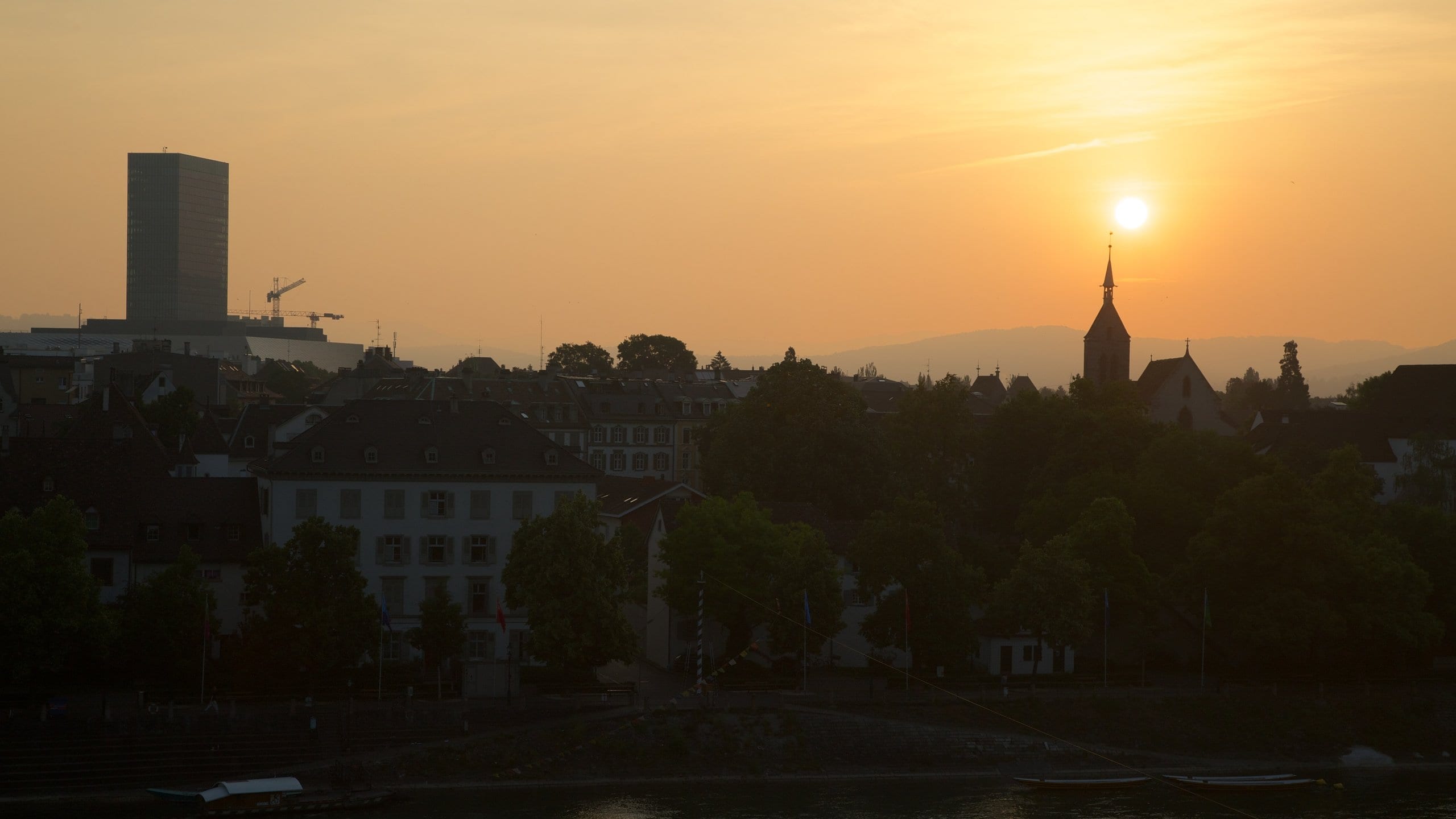 Basel featuring a sunset and a city