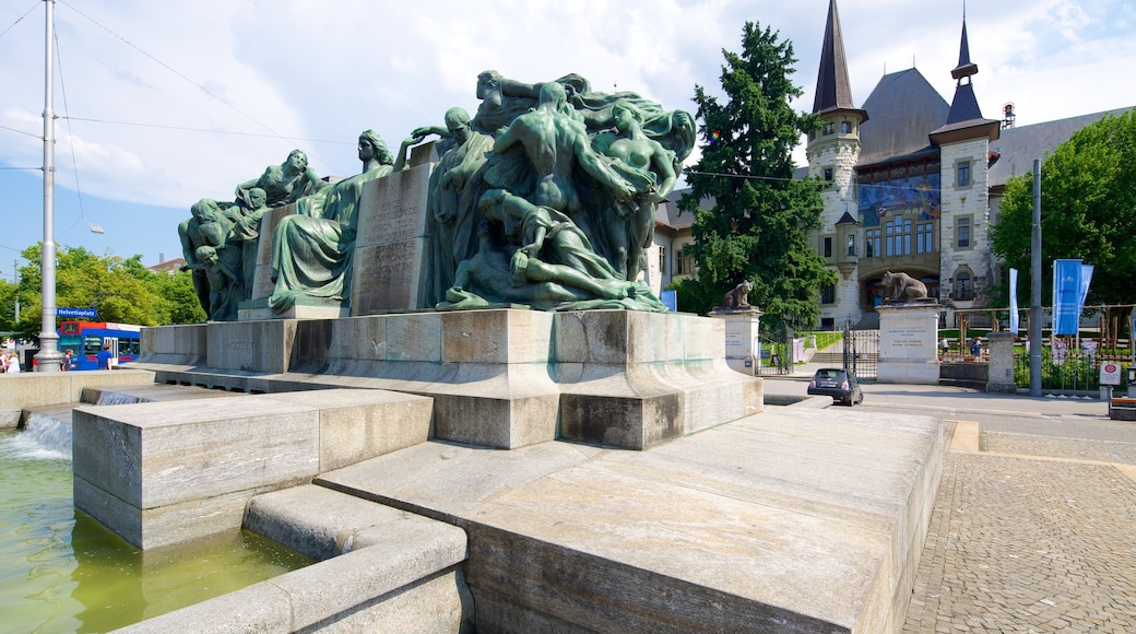 Bern Historical Museum featuring a statue or sculpture, a pond and outdoor art