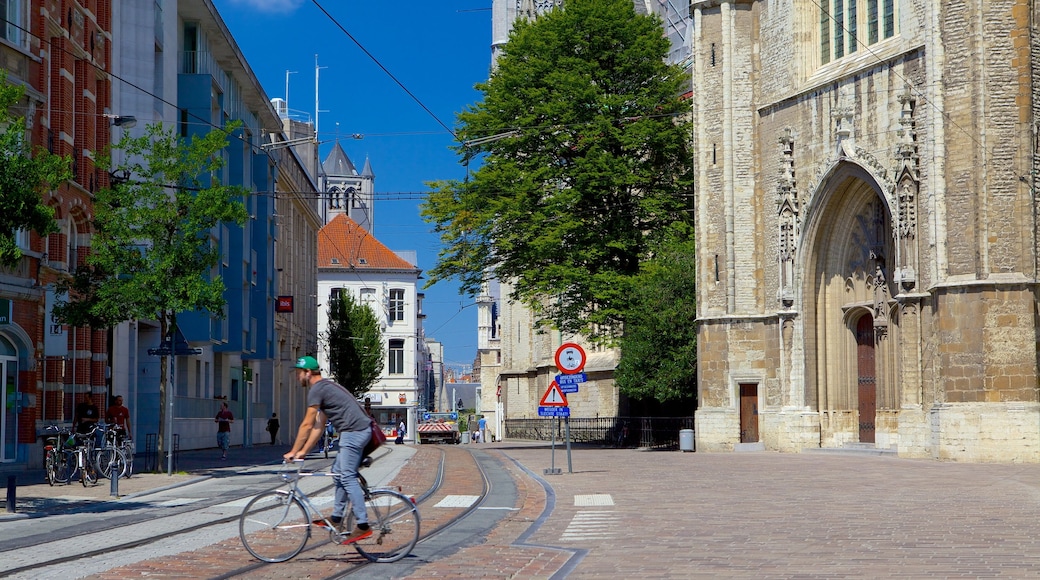 Saint Bavo Cathedral featuring cycling and street scenes as well as an individual male