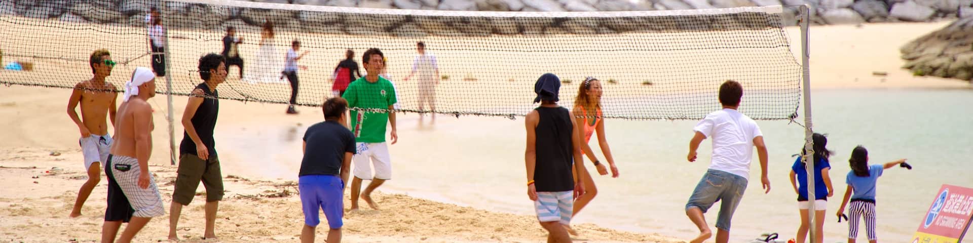 Chatan featuring a beach as well as a large group of people