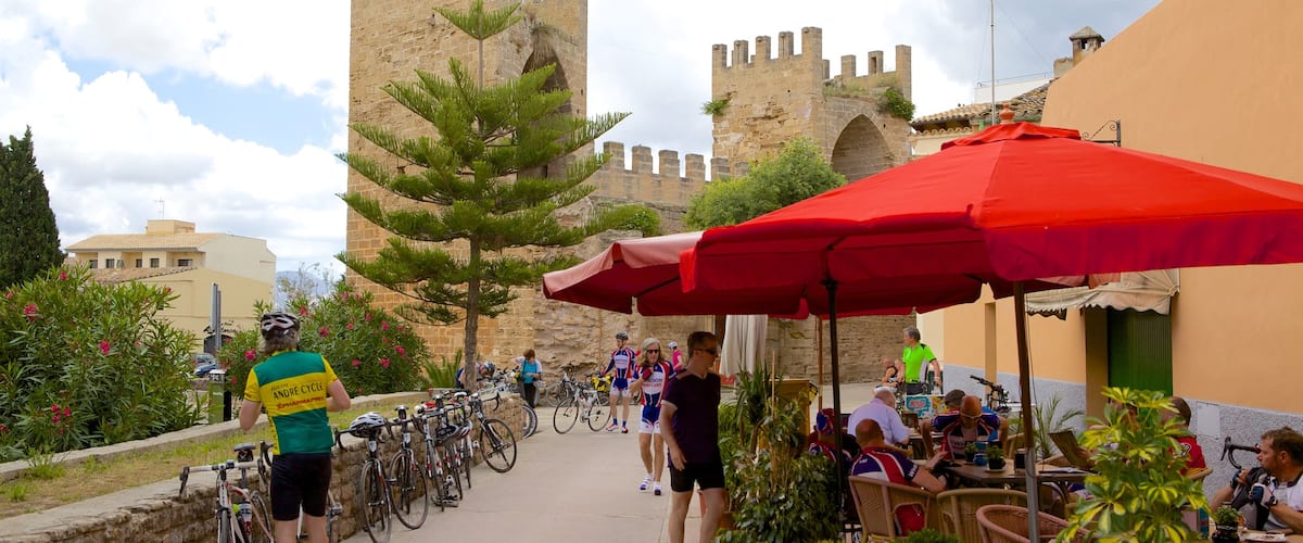 Alcudia which includes château or palace, heritage architecture and outdoor eating