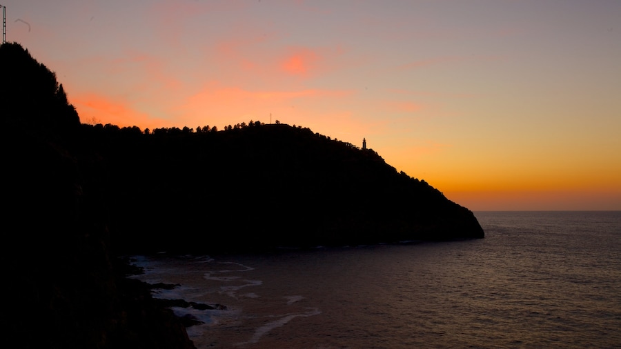 Port de Soller Lighthouse which includes general coastal views and a sunset