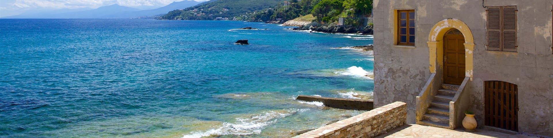 Brando which includes general coastal views, a house and heritage architecture