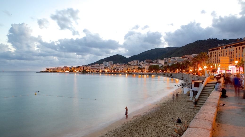 Ajaccio featuring a coastal town, a sandy beach and a sunset