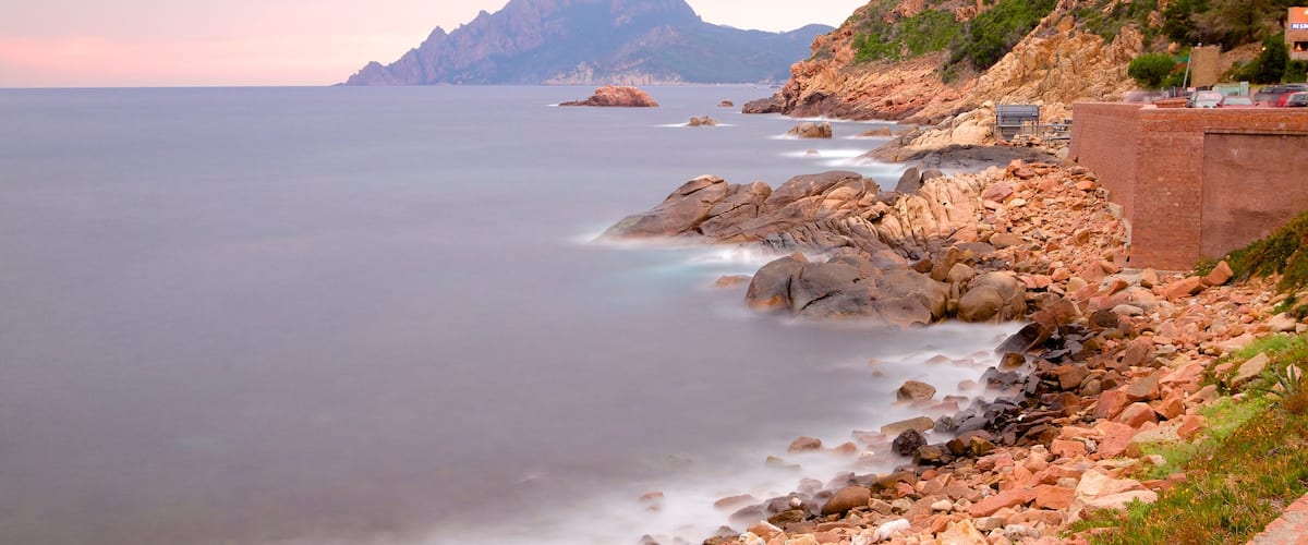 Genoese Tower featuring a sunset and rocky coastline
